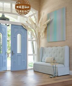 a living room with blue doors and white furniture