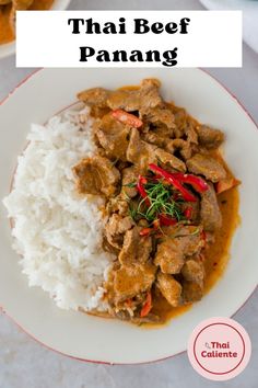 a white plate topped with rice and meat