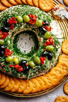 a platter filled with crackers and olives