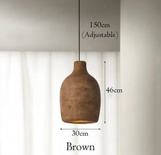 a brown vase hanging from the ceiling with measurements for it's height and width