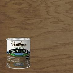 a can of stain and spar on top of a wooden surface with the words varnishe one step