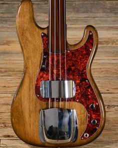 an electric bass guitar sitting on top of a wooden table