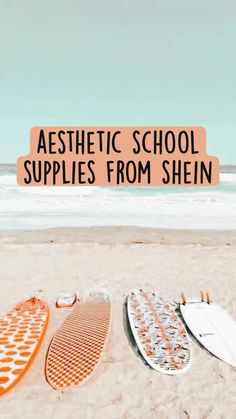 two surfboards laying on the beach with text overlay reading aesthetic school supplies from shein