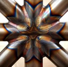 an image of a star shaped object that looks like it has been made out of metal pipes