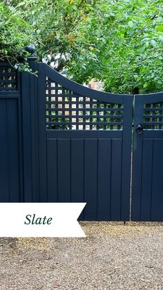 a blue gate with the words state on it and an image of trees in the background