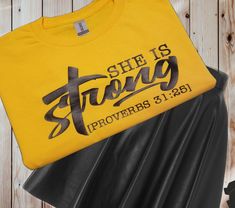 a t - shirt that says she is strong with the word provers on it