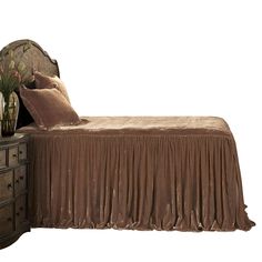 a bed with a brown bedspread and two vases on top of it