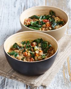 two bowls filled with food sitting on top of a table