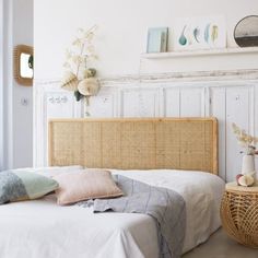 a wicker headboard in a bedroom with white walls