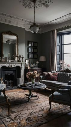 a living room filled with furniture and a fire place in front of a large window