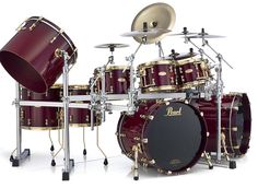 a red drum set with gold hardware