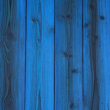 the wood is blue and it looks like it has been painted