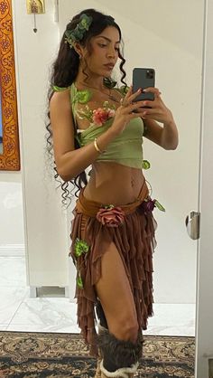 a woman in a hula skirt is taking a selfie with her cell phone