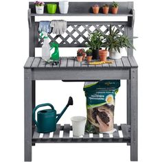 an outdoor shelf with potted plants and gardening tools on it, including a watering can