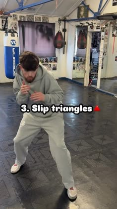 a man standing in a gym holding his hands together