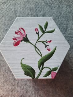 a painted wooden box with pink flowers on the inside and green leaves on the outside