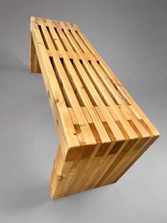 a wooden bench sitting on top of a white floor