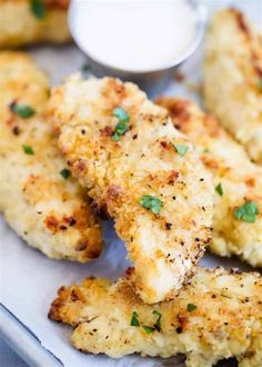 chicken tenders with ranch dressing on the side, ready to be eaten and served