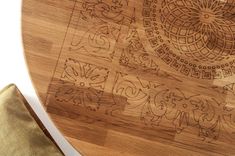 a close up of a wooden table with designs on the top and bottom part of it