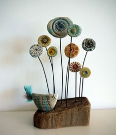 a wooden block with some decorative items on it's top and one bird in the middle