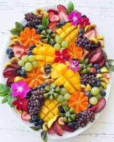 a white plate topped with lots of different types of fruit