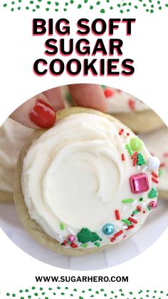 a hand holding a cookie with frosting and sprinkles on it that says, big soft sugar cookies