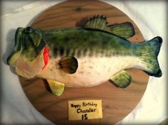 a birthday cake shaped like a fish on a plate