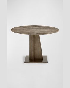 a round wooden table sitting on top of a metal base