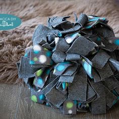 a pile of fabric sitting on top of a wooden floor next to a brown rug