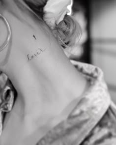 the back of a woman's neck with writing on it