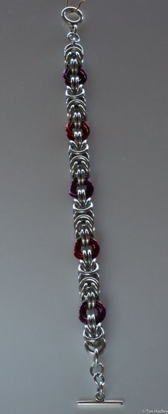 This is a chainmail bracelet made of Bright Aluminum (silver) and Anodized Aluminum (colors). It is a Byzantine chain interspersed with colored Mobius knots. I can lengthen or shorten it (additional $5/inch to lengthen), change the clasp (price depends on clasp selected), and change the color of the knots for $1/knot. Why aluminum? It's lightweight yet strong, making it comfortable to wear yet durable. It does not tarnish, but there are rare instances of a slight grey rub-off that can occur. This easily washes off. If the jewelry becomes dirty or dingy, it can be washed with soap and water or a vinegar and baking soda soak. I can make similar items in different weights or colors, as well as different materials such as stainless steel, sterling silver, copper, argentium, and more. If you do Mens Chainmail Bracelet, Chainmail Ornaments, Chainmail Jewelry Patterns, Diy Chainmail, Chainmail Diy, Chainmaille Jewelry Patterns, Chain Maille Patterns, Chainmail Patterns, Jump Ring Jewelry