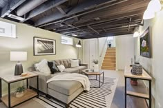 a living room filled with furniture and a stair case next to a fire hydrant