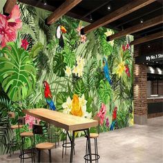 an image of a tropical themed wallpaper with birds and flowers on the walls in a restaurant