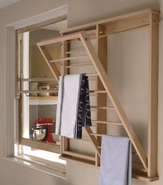 a wooden shelf with towels hanging on it