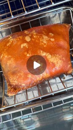 a piece of meat sitting on top of an oven rack