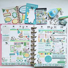 an open planner book with stickers on it