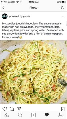 a plate full of noodles and vegetables on top of a table with a spoon in it