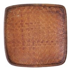 an old woven brown tray on a white background