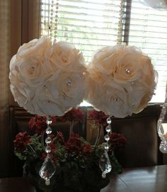 two vases filled with flowers on top of a table