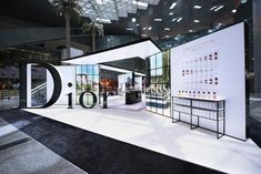 an exhibition stand with lots of white and black items