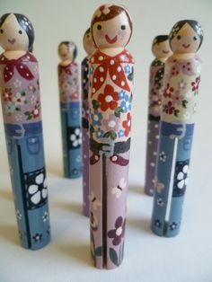 several wooden dolls are lined up in a row