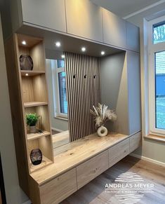 a large wooden shelf sitting next to a window