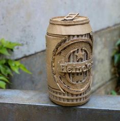 a brown beer can sitting on top of a cement bench