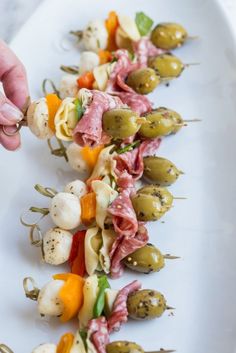 finger foods are arranged on a white plate