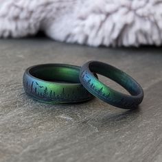 two rings with trees on them sitting on a table