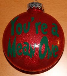 a red ornament with the words you're a mean one on it