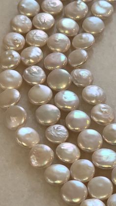 a strand of white pearls on a table