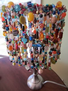 a lamp made out of glass beads on a table