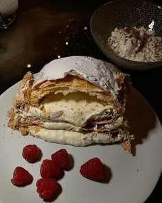 a dessert is on a white plate with raspberries