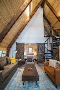 a living room filled with furniture and a spiral staircase